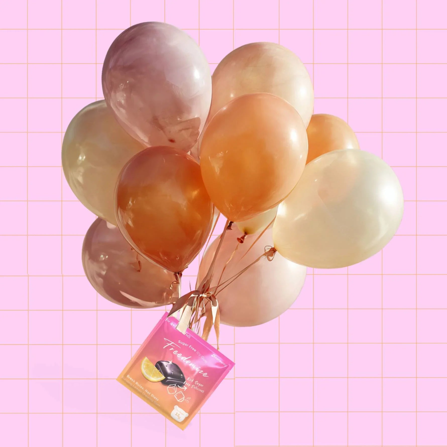 A bunch of pastel balloons tied together with a Freedomize bursting lemon Sugar Free Icy Gum pouch against a pink grid background.