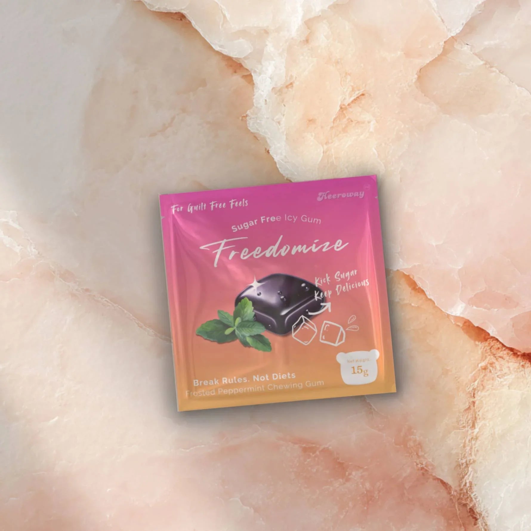 Floating Freedomize frosted peppermint Sugar Free Icy Gum pouches on a pink background showing both front and back packaging.