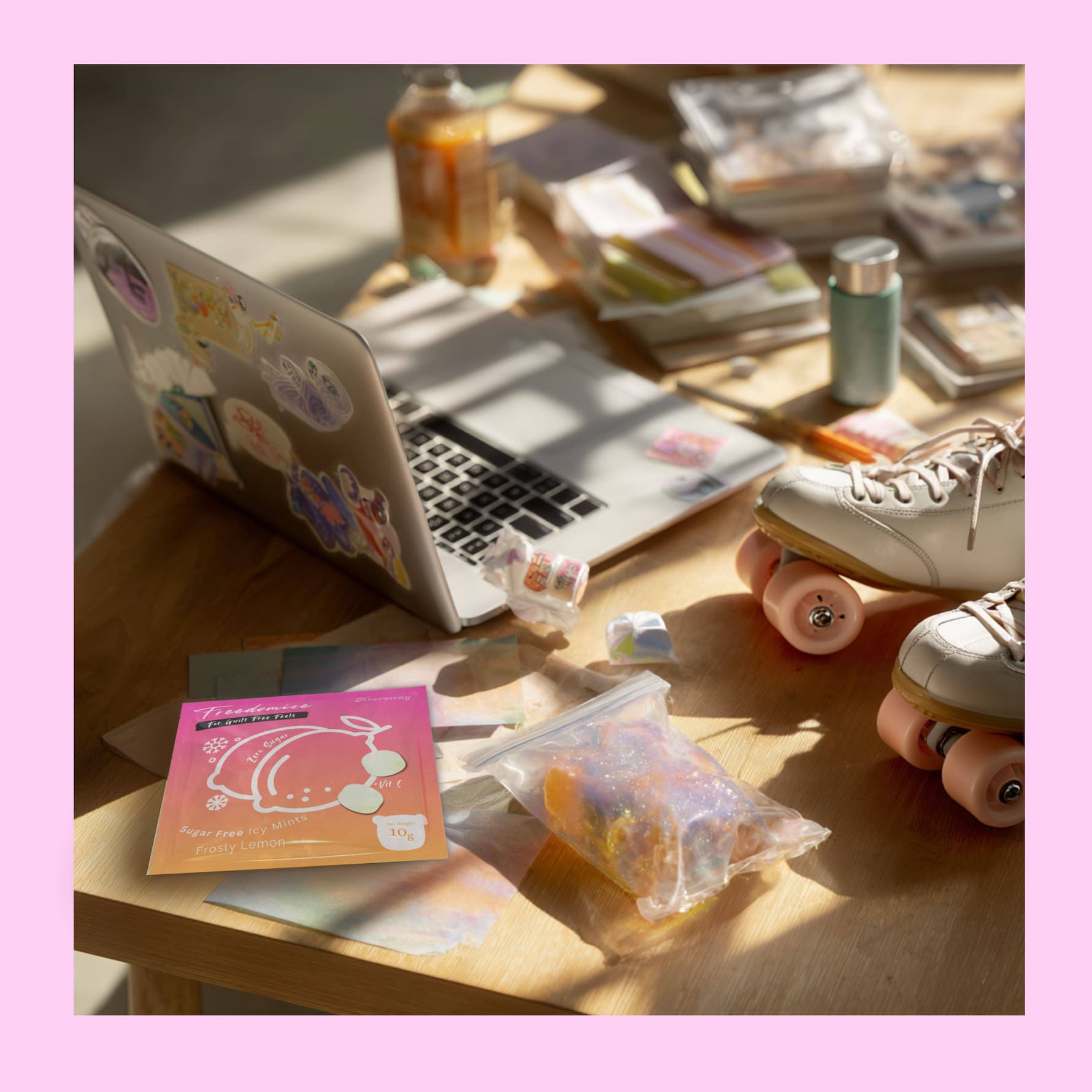 freedomize frosty lemon sugar free icy mints packaging on wooden desk with laptop roller skates drinks and stationery in sunlight