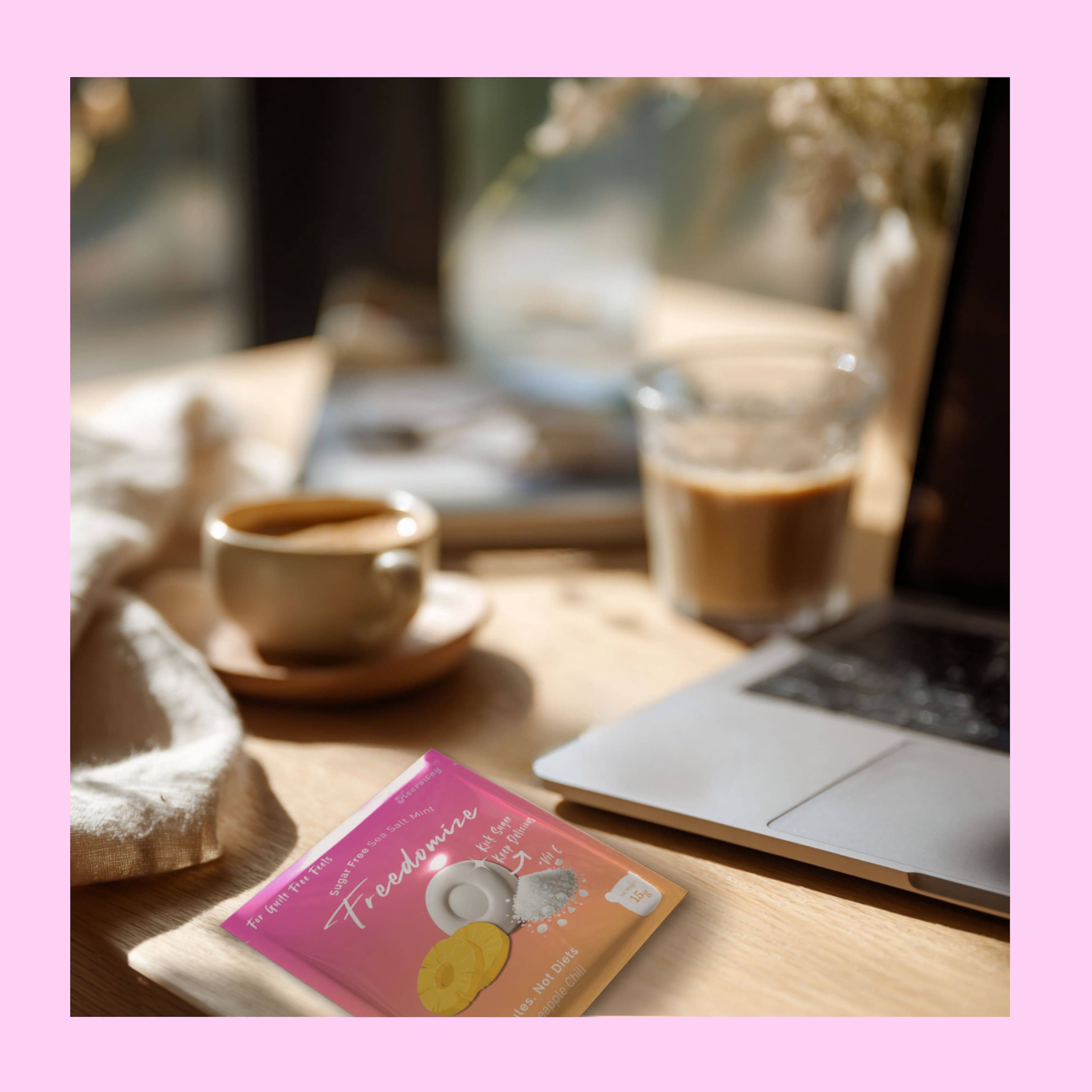freedomize lemon lime sugar free sea salt mint packaging on wooden desk with coffee glass laptop and soft sunlight