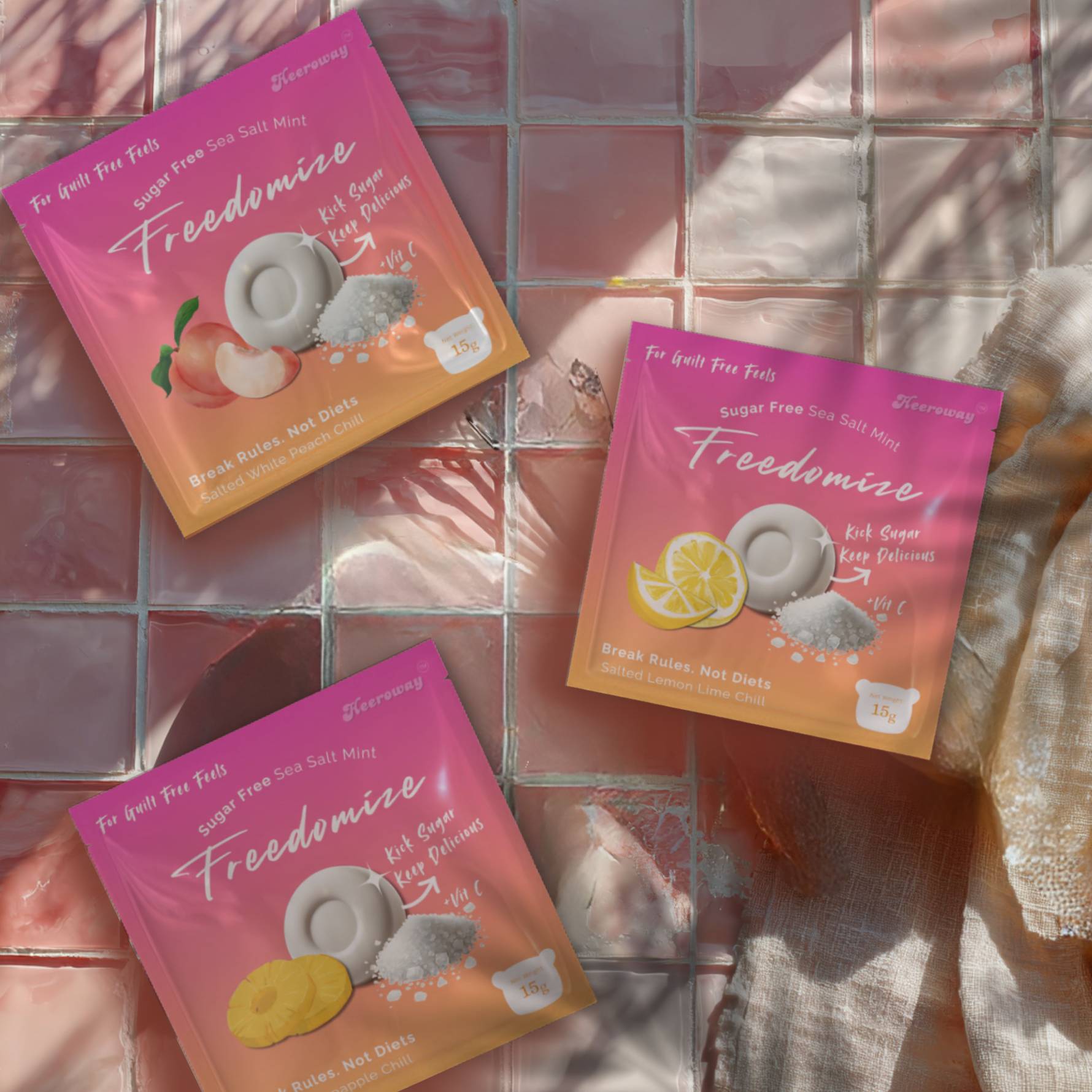 Freedomize sugar free sea salt mints flat lay with peach, lemon lime, and pineapple flavors on pink tiled background