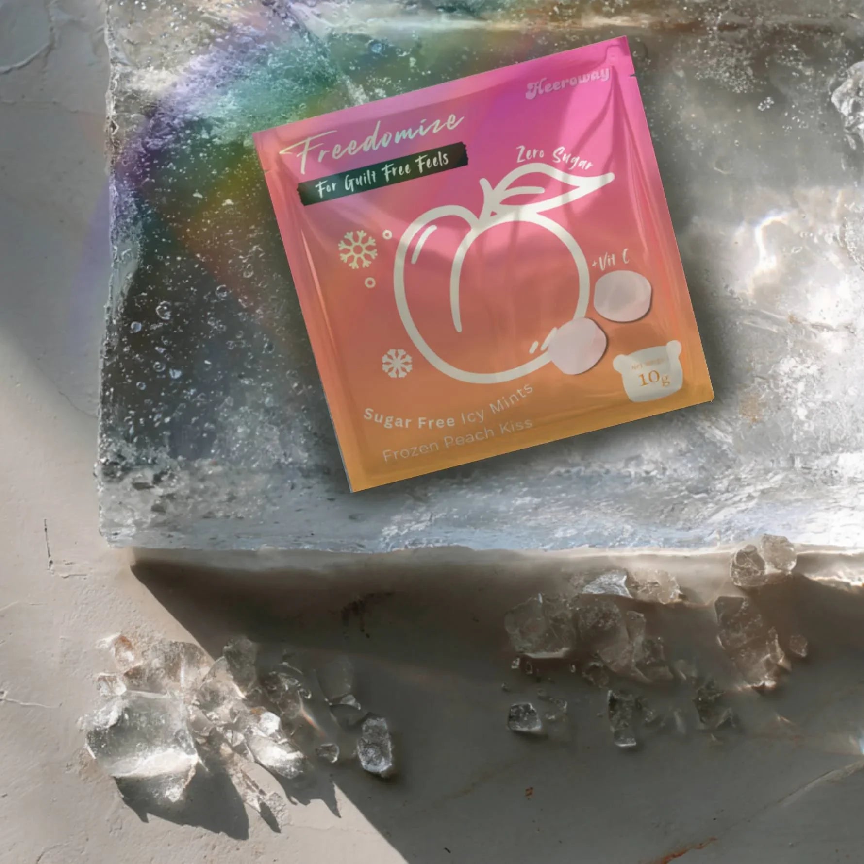 Heeroway Freedomize Frozen Peach Kiss Sugar Free Icy Mints pouch floating against a pink background, showing front and back packaging.