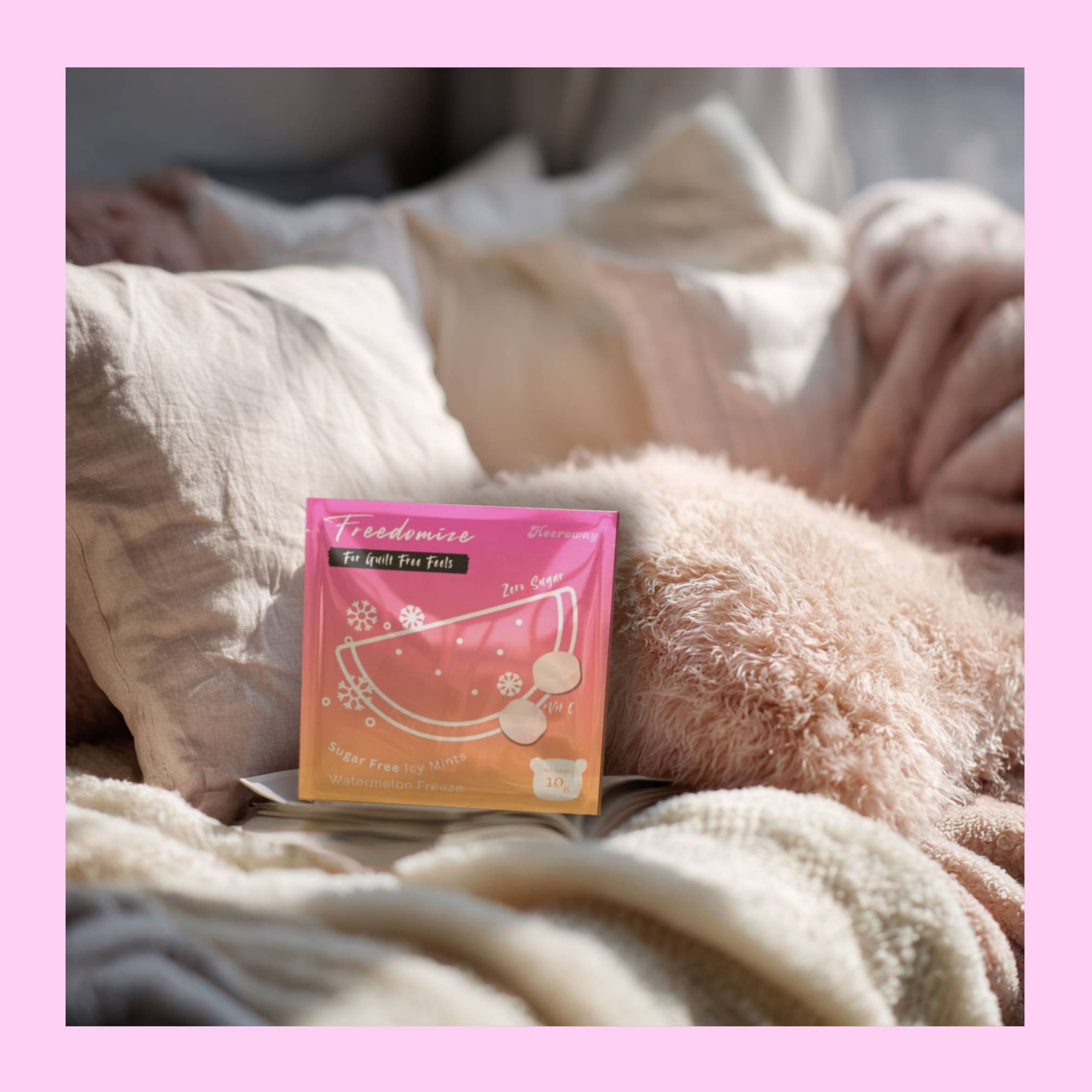 Freedomize sugar free icy mints Watermelon Freeze flavor pouch placed on cozy pillows with a pink border.