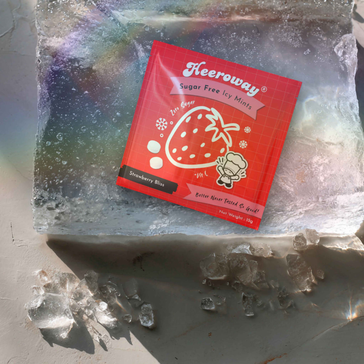 A red packet of Heeroway Sugar Free Icy Mints, Strawberry Bliss flavor, styled inside a clear ice block with scattered ice crystals on a gray surface.